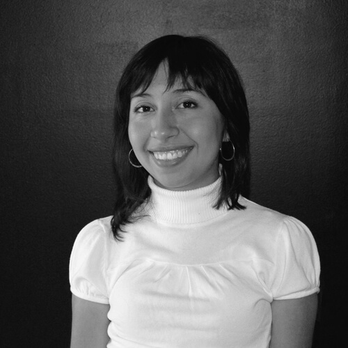 f894b52d5bc1ecb6a70e81f51eb28322 Headshot of Reveca, smiling