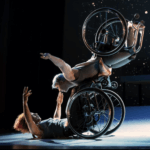 Two dancers with wheelchairs, from Kinetic Light's performance of Descent